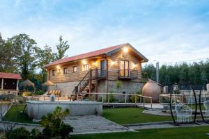a house with lights on the front of it at Quinta Ze do Coval in Arouca