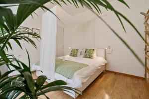 a bedroom with a bed in a room with a plant at Vlaeberg Birdhouse in Diksmuide