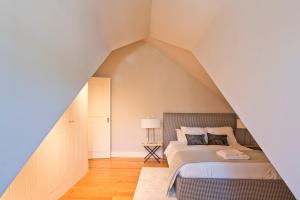 a bedroom with two beds in a attic at Iconic & Elegant Design 2 bedroom Apt By FS in Lisbon