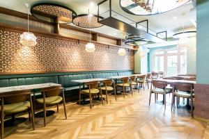 a row of tables and chairs in a restaurant at LX SoHo Boutique Hotel by RIDAN Hotels in Lisbon