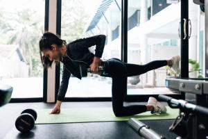 a woman doing a push up in a gym at Sarikantang Resort & Spa, Koh Phangan in Haad Rin