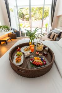 a tray of food on a table in a living room at Sarikantang Resort & Spa, Koh Phangan in Haad Rin