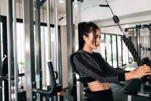 a woman is in a gym with an umbrella at Sarikantang Resort & Spa, Koh Phangan in Haad Rin