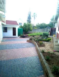 a brick driveway in front of a house at Ezamampondo Guest House in King Williamʼs Town
