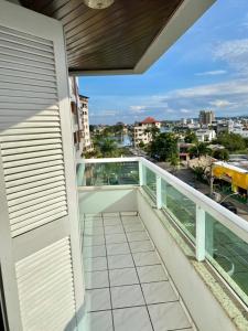 a balcony with a view of a city at Residencial Nápole in Torres