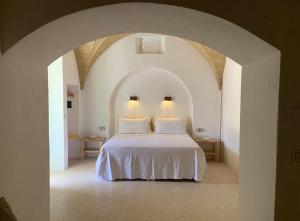 Posteľ alebo postele v izbe v ubytovaní Relais Masseria Sant'Antonio
