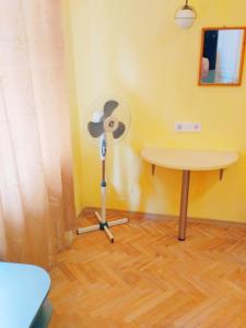 a room with a table and a fan and a table at Lviv appartment on Yaroslava Mudrogo 14 in Lviv