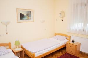 a bedroom with two beds and a picture on the wall at Mostar Orient in Mostar