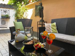 a table with wine glasses and fruit on a patio at Haus Christine in Traben-Trarbach in Traben-Trarbach