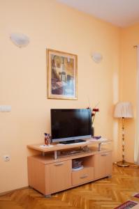 a living room with a flat screen tv on a cabinet at Mostar Orient in Mostar