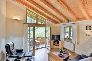 a living room with a couch and a tv at Fewo Ammertal in Oberammergau