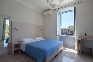 Cecio 5 Terre Rooms tesisinde bir odada yatak veya yataklar