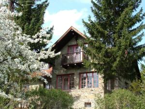 a stone house with red windows and a balcony at Gereben Villa in Velem