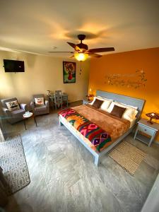 a bedroom with a large bed and a living room at Inn The Coffeepot - Boutique Hotel in Boquete