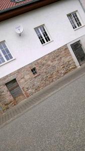 a brick building with windows and a satellite at Landhaus im Hunsrück in Henau