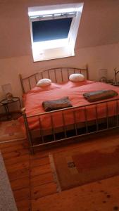a bed in a bedroom with a window at Landhaus im Hunsrück in Henau