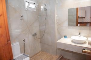 a bathroom with a shower and a sink and a toilet at Danelis Studios & Apartments in Malia +45 photos