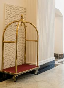 a gold and red chair in a room at Hotel Majestic in Casablanca