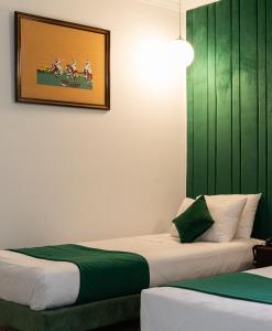 two beds sitting next to each other in a room at Hotel Majestic in Casablanca
