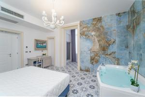 A bed or beds in a room at PLAZA Boutique Hotel - Tropea Még 37 kép