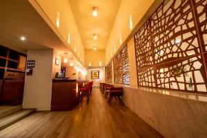 a restaurant with tables and chairs in a hallway at Emporio Acapulco in Acapulco