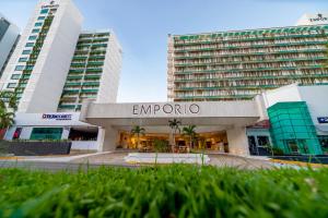 a building in front of two tall buildings at Emporio Acapulco in Acapulco