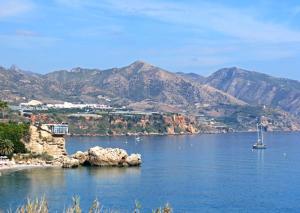 a large body of water with a boat in it at Fuentes de Nerja in Nerja