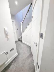 an empty room with a door and a staircase at Modern Maisonette 2 Bedrooms Newly Renovated in Bournemouth