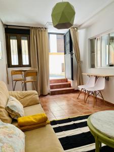 a living room with a couch and a table at CÓMODO APARTAMENTO RURAL in Torrelaguna