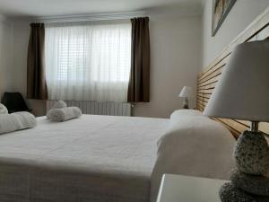 a bedroom with a large bed and a window at Cal Roig Hotel Rural in Vilafranca del Penedès