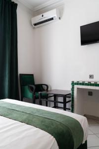 a bedroom with a bed and a table and chairs at Hotel Majestic in Casablanca