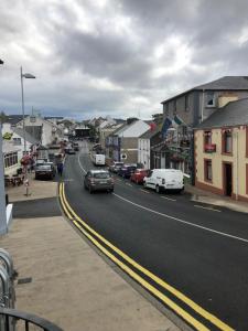 a city street with cars parked on the side of the road at Ard Cashel in Dungloe