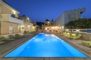 a swimming pool in the middle of a house at Olive Grove Apartments in Elounda +20 photos