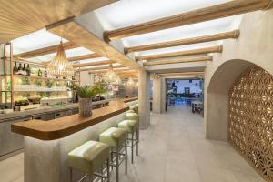 a bar in a restaurant with stools at a counter at Olive Grove Apartments in Elounda