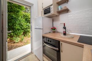 a kitchen with a refrigerator and a counter with a sink at House Daniva in Okuklje
