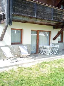 a pair of chairs and a table on a patio at Appart terrasse Superdevoluy in Le Dévoluy +7 photos