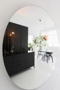 a kitchen with a sink and a table in a mirror at Trilogy Black in Thessaloniki