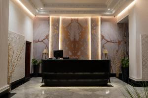 a hotel lobby with a reception desk and a wall at Hotel Majestic in Casablanca