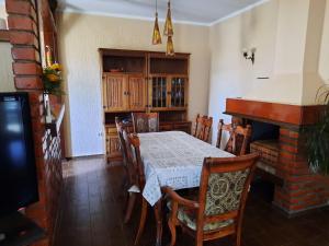 a dining room with a table and a fireplace at Holiday Home Panorama House in Herceg-Novi