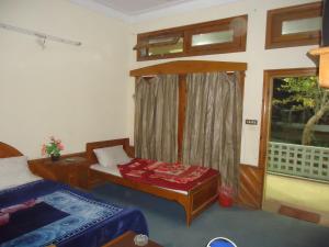 KārandūkaiにあるHotel Marcopolo kalamのベッドと窓が備わる小さな客室です。