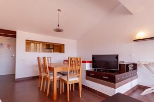 a dining room with a table and a television at Clipper 309 in La Manga del Mar Menor