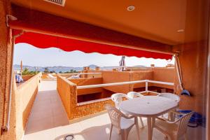 a balcony with a table and chairs and a view at Clipper 309 in La Manga del Mar Menor