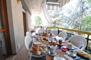 a table with breakfast food on a balcony at Sole & Querce Apartments- Bike Friendly with garage in Lanciano