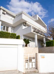 a white house with a white garage at Apartment Pčelica Maja in Podstrana