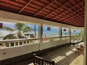 a building with a balcony with a view of the beach at Neela Waters - Beach Home in Alleppey