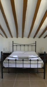 a black bed in a room with a ceiling at Casa De Los Sueños in Zurgena