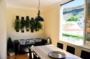 a dining room with a table and a window at Green Element Guesthouse in Costa da Caparica