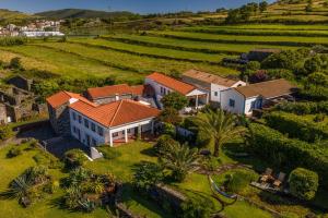 an aerial view of a house in a field at Quinta Perpetua, Casa Flores in Santa Cruz da Graciosa
