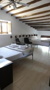 a room with two beds and a ceiling with beams at Casa De Los Sueños in Zurgena