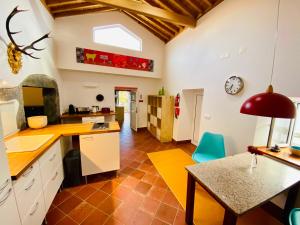 a kitchen with a table and a dining room at Quinta Perpetua, Casa Flores in Santa Cruz da Graciosa